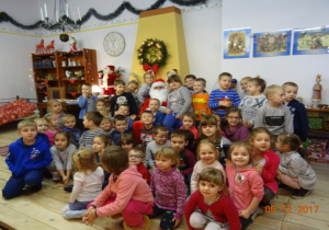Dzieci wspólnie z Mikołajem pozują do zdjęcia.